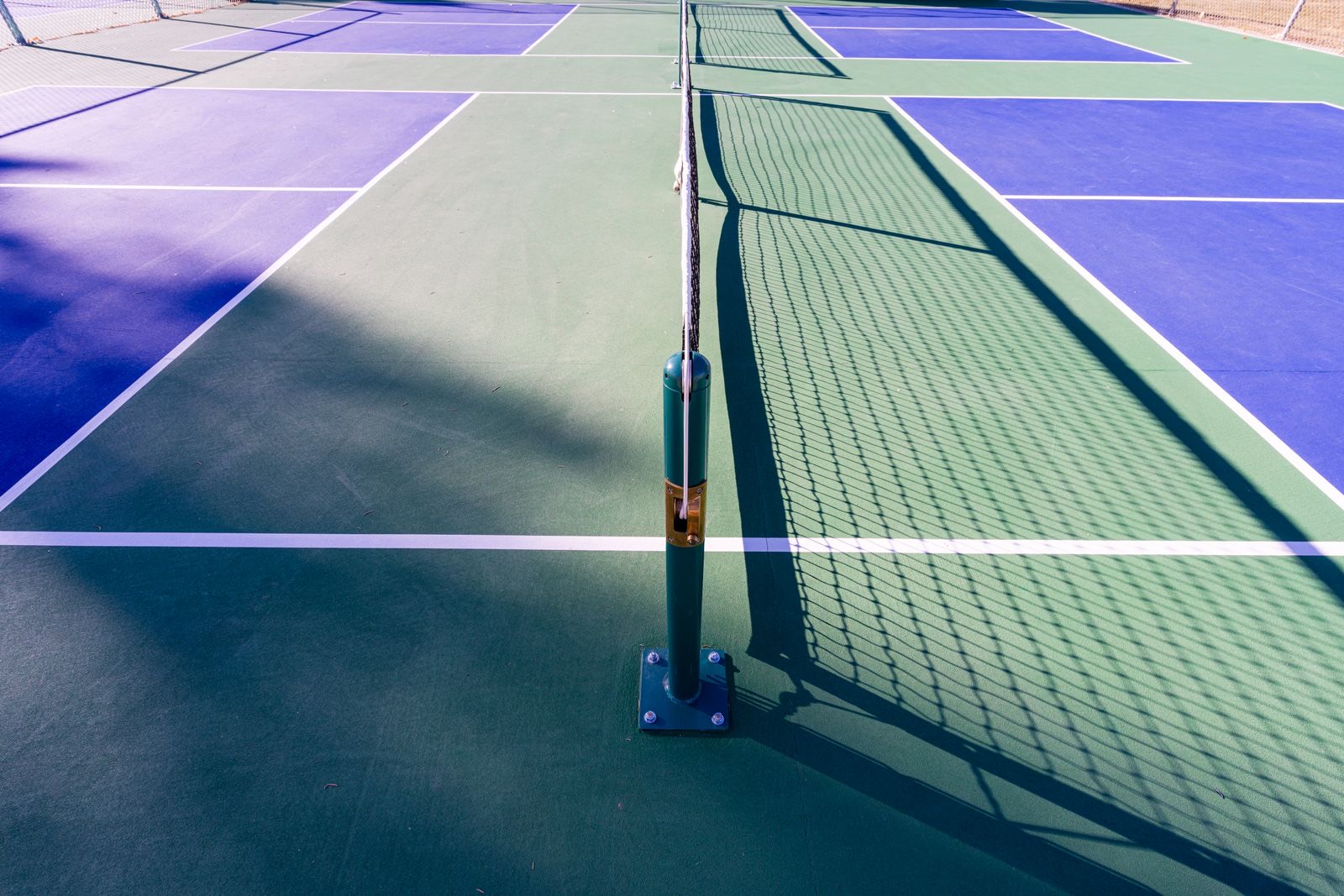 Pickleball court after professional cleaning — vibrant blue and green surface